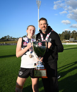 Best on Ground winner, Sunny Lappin, pictured with her coach and father, Matthew Lappin and the 2025 Premiership Cup.