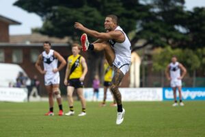 Sam Lowson kicks for goal