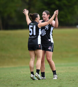 Southport Sharks Reserves celebrate a goal.